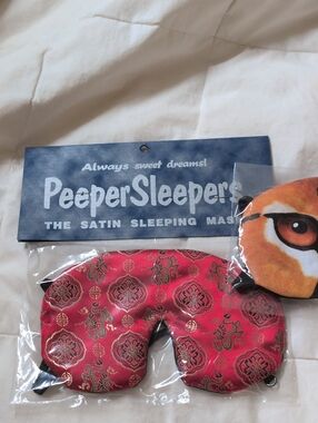 two peeper sleepers silk sleep masks. one tiger and one asian dragon motif.
